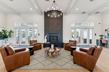 A living room with a fireplace and a chandelier.